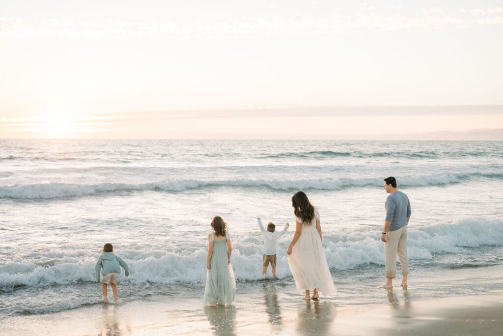 A family at a South Bay beach wearing neutral colored clothing for their family beach photos.