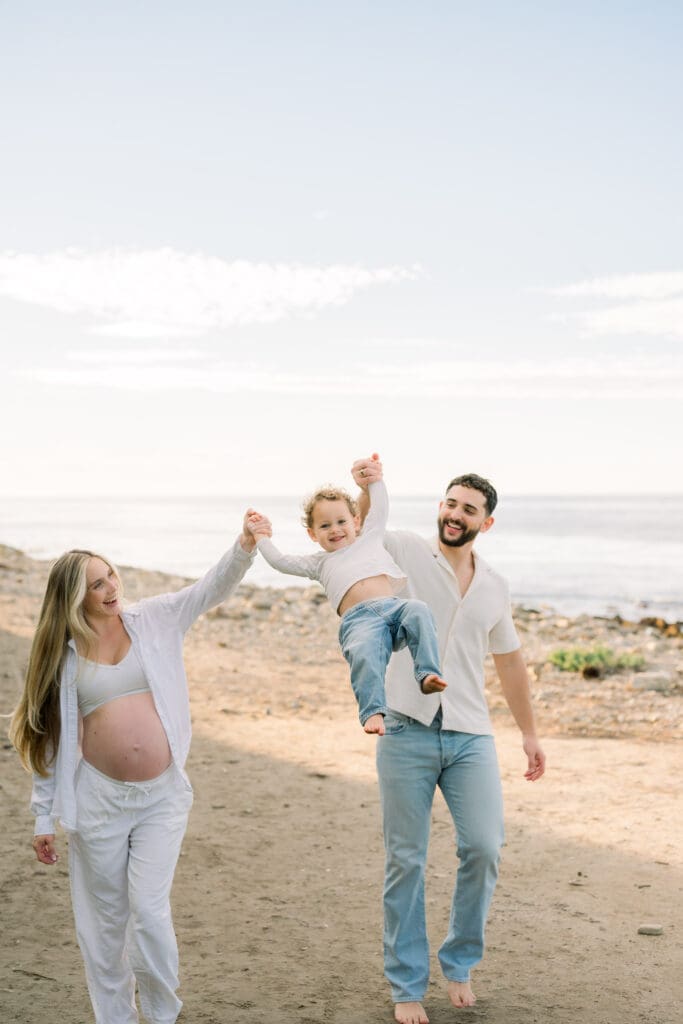 A family taking casual beach maternity photos on a South Bay beach.