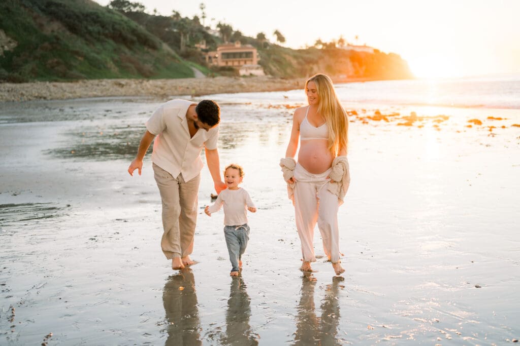 A family posing for casual beach maternity photos in the South Bay.