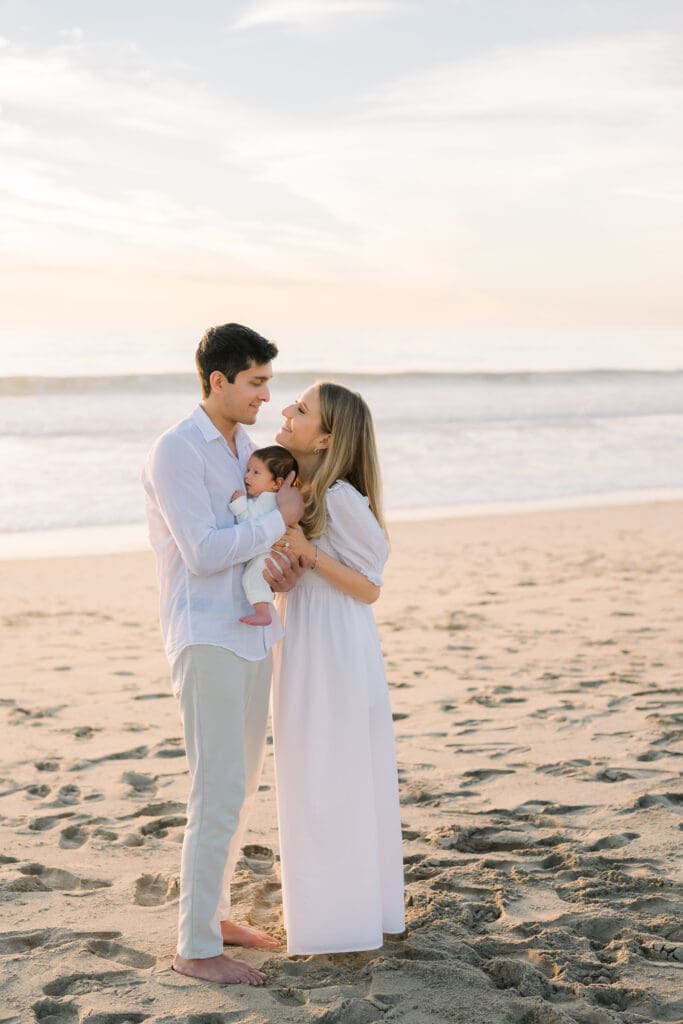 A new family taking newborn photos with a Hermosa Beach newborn photographer.