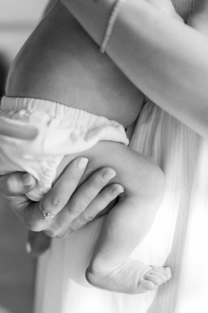 A close up of a newborn baby in black and white.