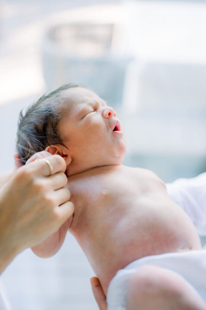 A sweet photo of a newborn baby boy taking in home newborn photos in Los Angeles.