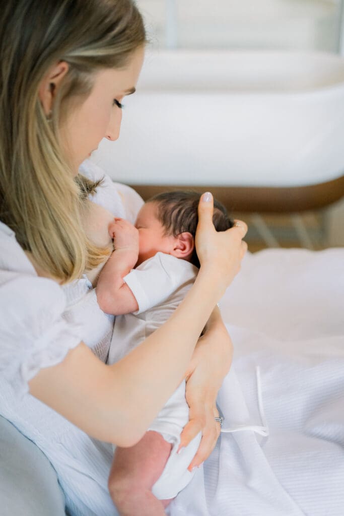 Mom breastfeeding her newborn baby during their in home newborn photography session in Los Angeles.