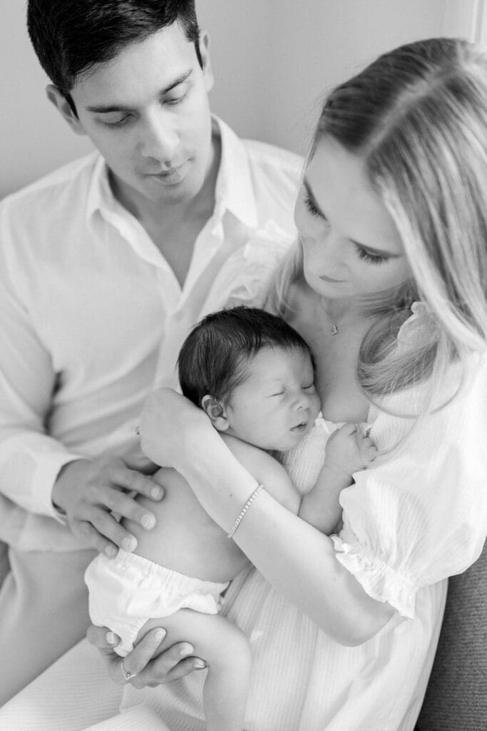 A black and white photo of a sleeping newborn baby at his in home newborn photography photo shoot in Los Angeles.