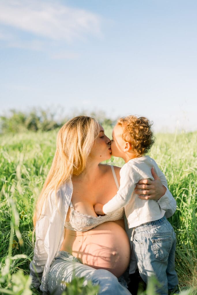 A Los Angeles maternity session featuring a mom and her little boy in tall green grass.