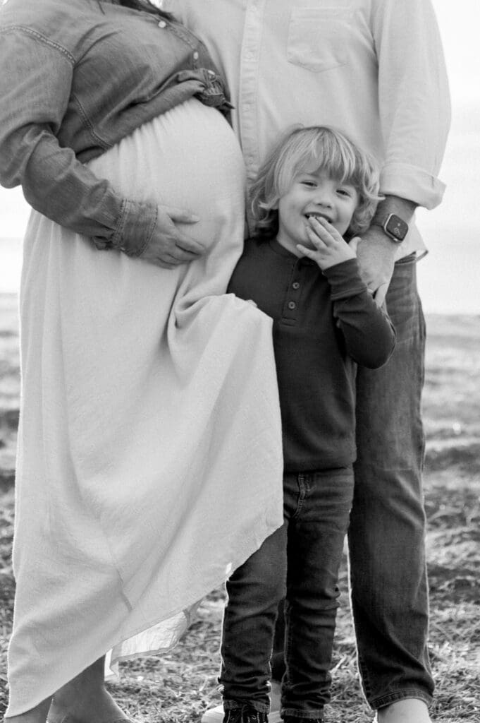 A little boy snuggles up with his mom and dad during their Los Angeles maternity session.