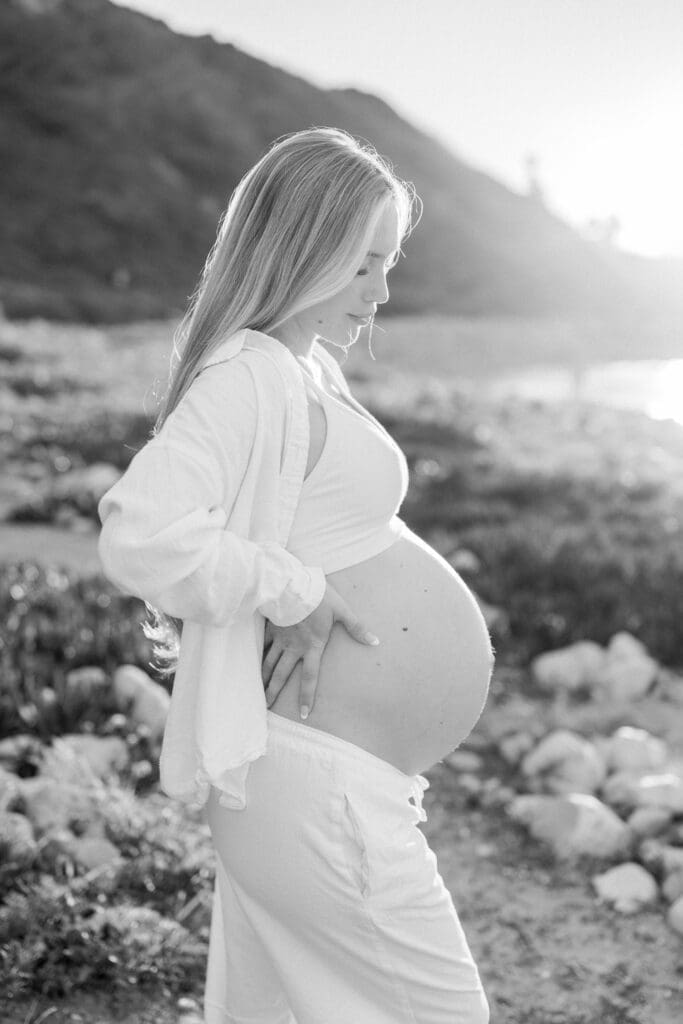 A pregnant mom posing on the beach during her Los Angeles maternity session.