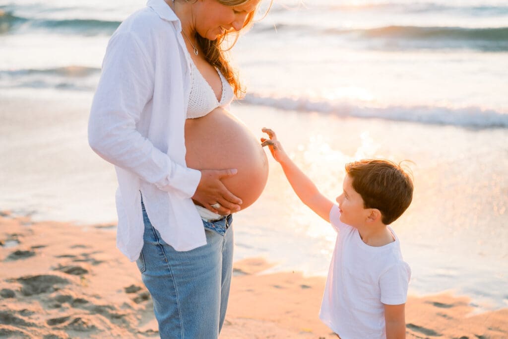 A Los Angeles maternity session with a mom and her young son on the beach at sunset.