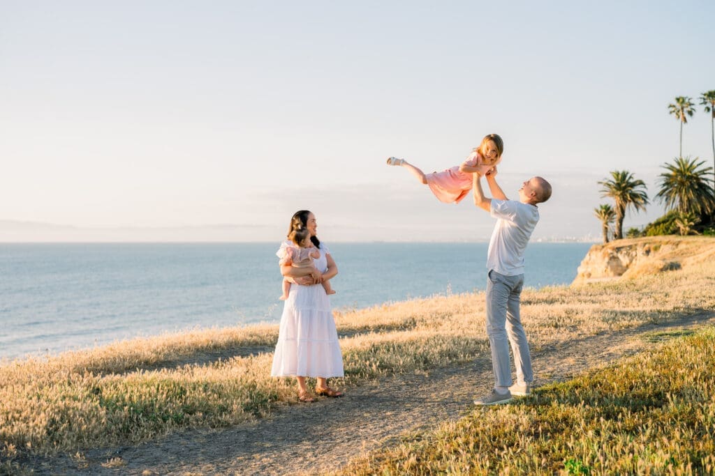 A family of 4 taking playful spring family portraits in Los Angeles.