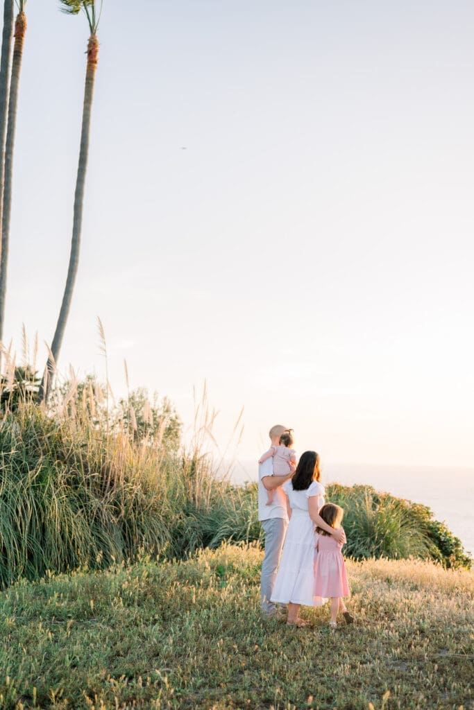 A family looking at the sunset on the Palos Verdes cliffs.
