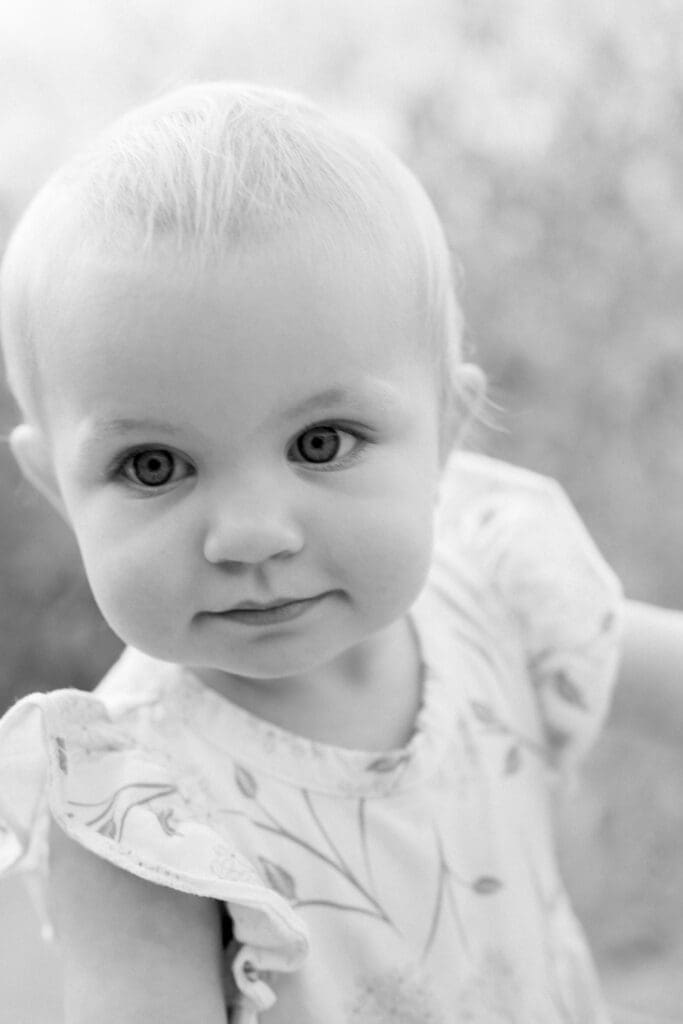 A black and white photo of a little girl.