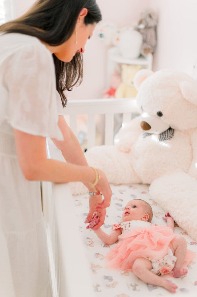 Mom tending to her newborn baby while taking newborn photos.