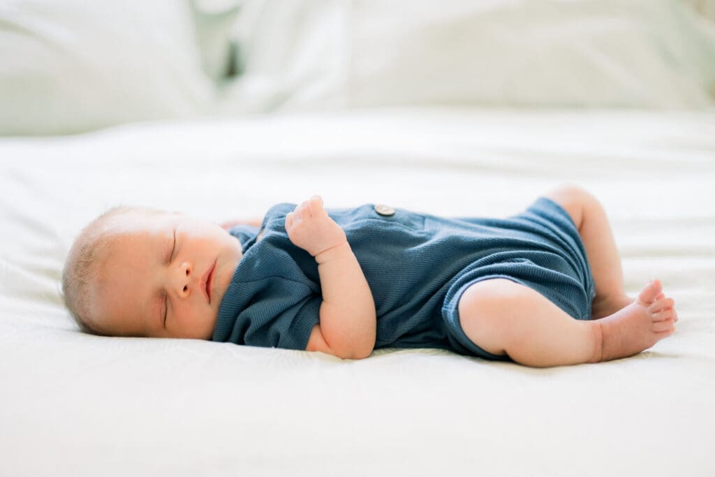 A newborn baby sleeping peacefully during his newborn photos.