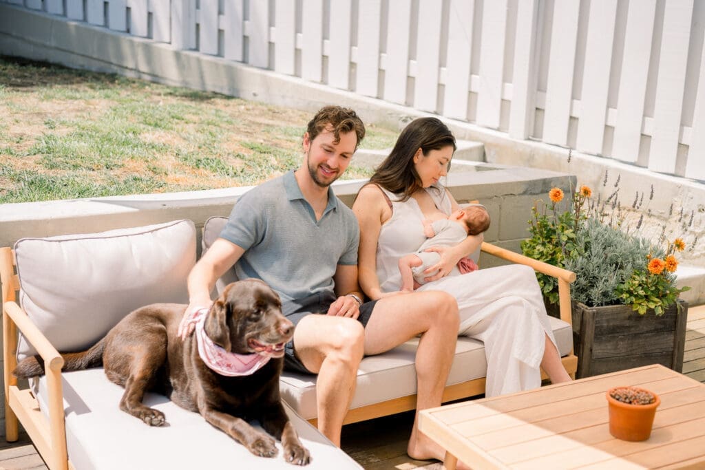 A family taking newborn photos in their home with their dog in the South Bay.