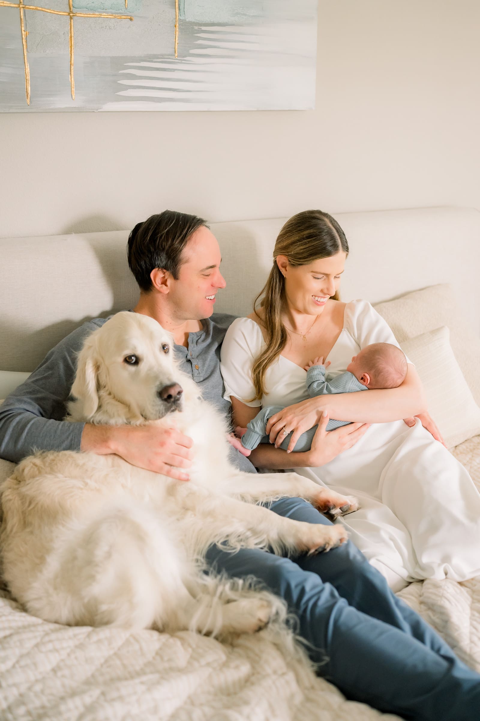 A family taking newborn photos at their home in the South Bay with their dog included.