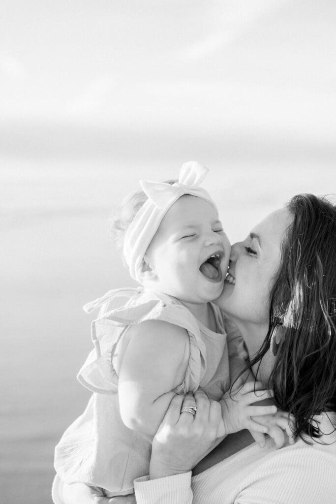 Mom and daughter laughing together while being photographed by a South Bay photographer.