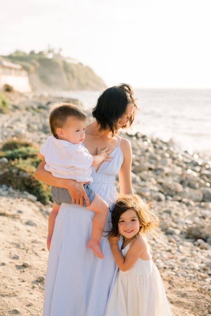 Mom and her kids posing for family photos in Palos Verdes at sunset.