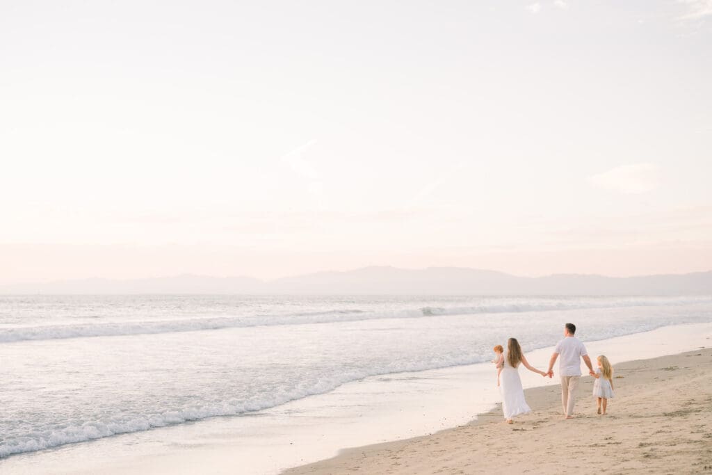 A family walking along Bruce's Beach, which is one of the best South Bay family photo locations.
