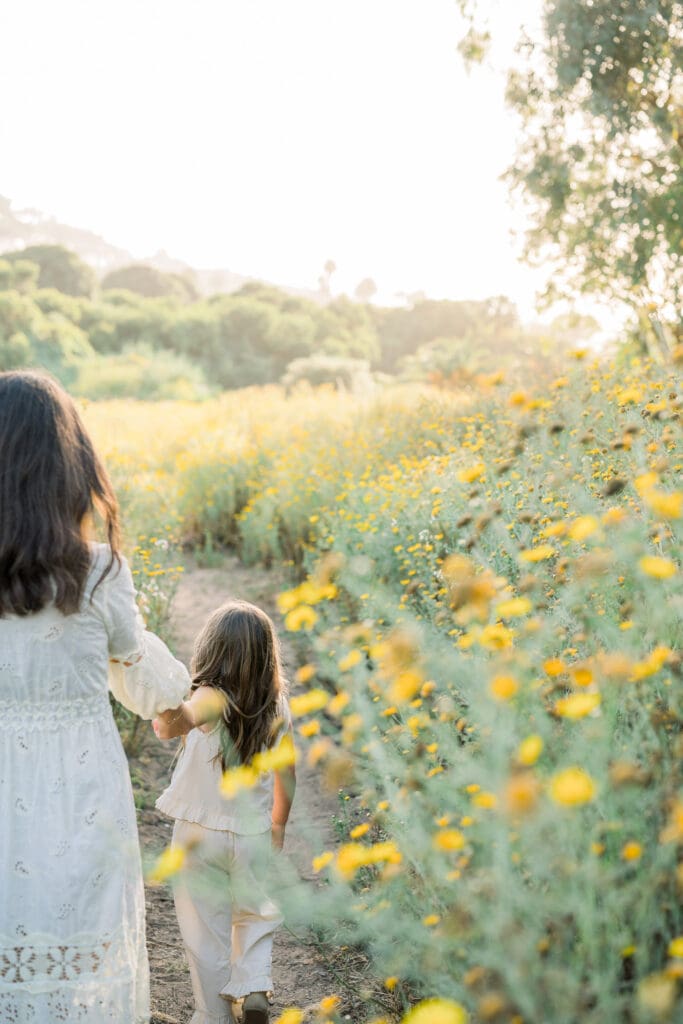 A little girl among the yellow wildflowers in the spring time in Palos Verdes.