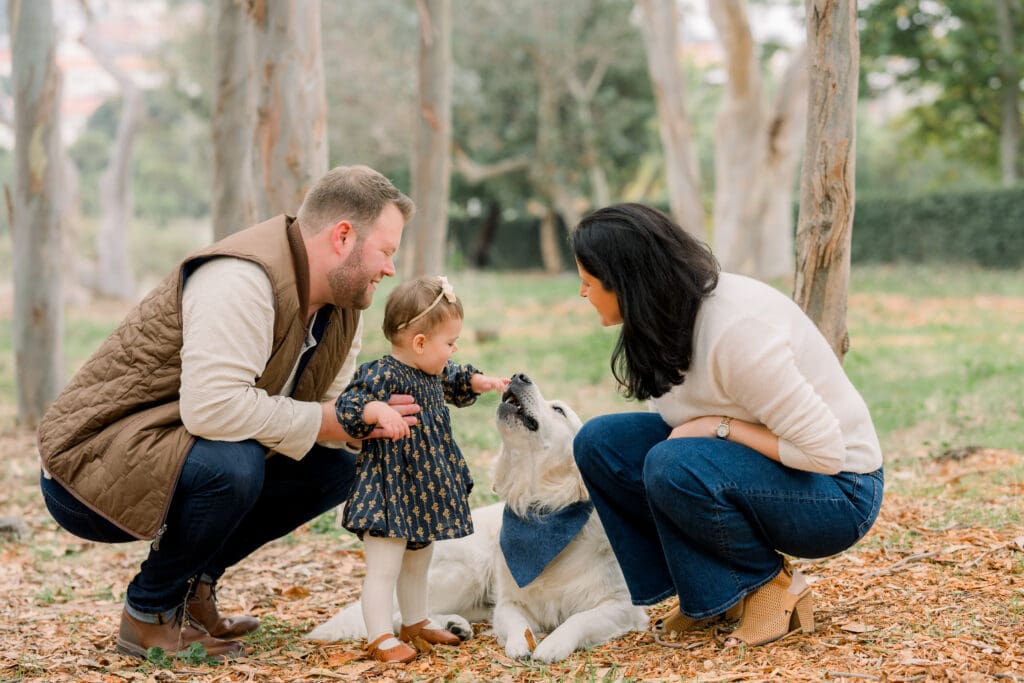 A little girl with her dog and parents doing a fall family photoshoot in the South Bay.